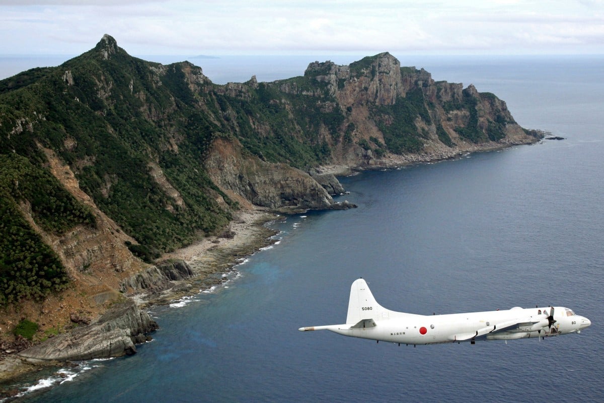 A Japanese Self-Defence Force P-3C Orion surveillance plane flies over the disputed islands in 2011. Photo: AP