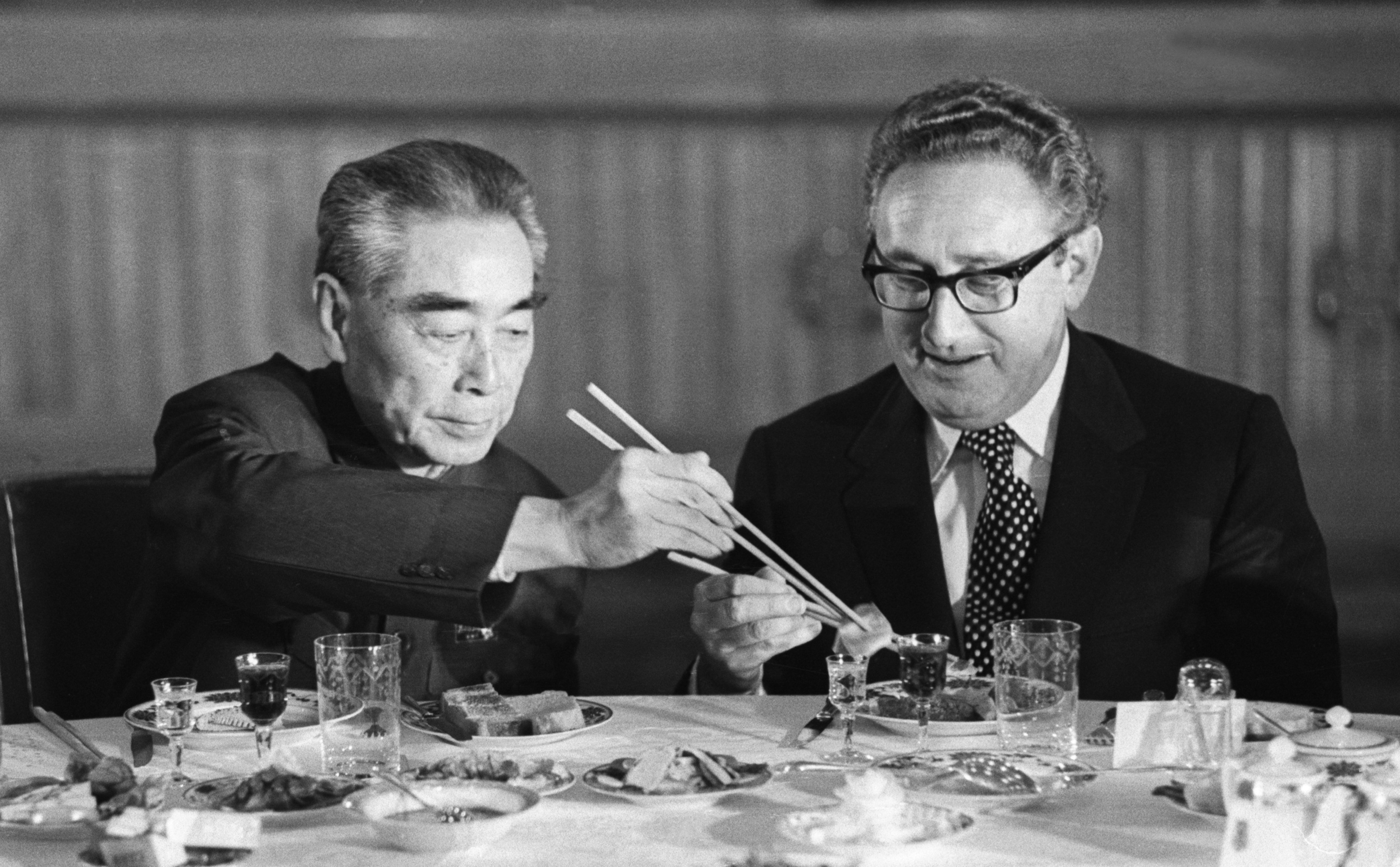 US secretary of state Henry Kissinger accepts food from Chinese premier Zhou Enlai during a state banquet in the Great Hall of the People in Beijing in 1973. Photo: Bettmann Archive