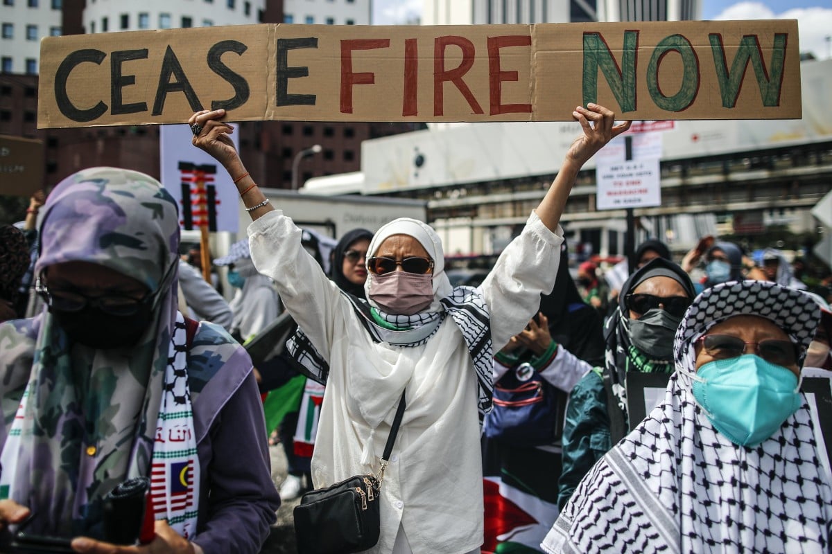 A woman holds a placard during a ‘Free Palestine’ rally near the US embassy in Kuala Lumpur on December 22, 2023. Photo: EPA-EFE