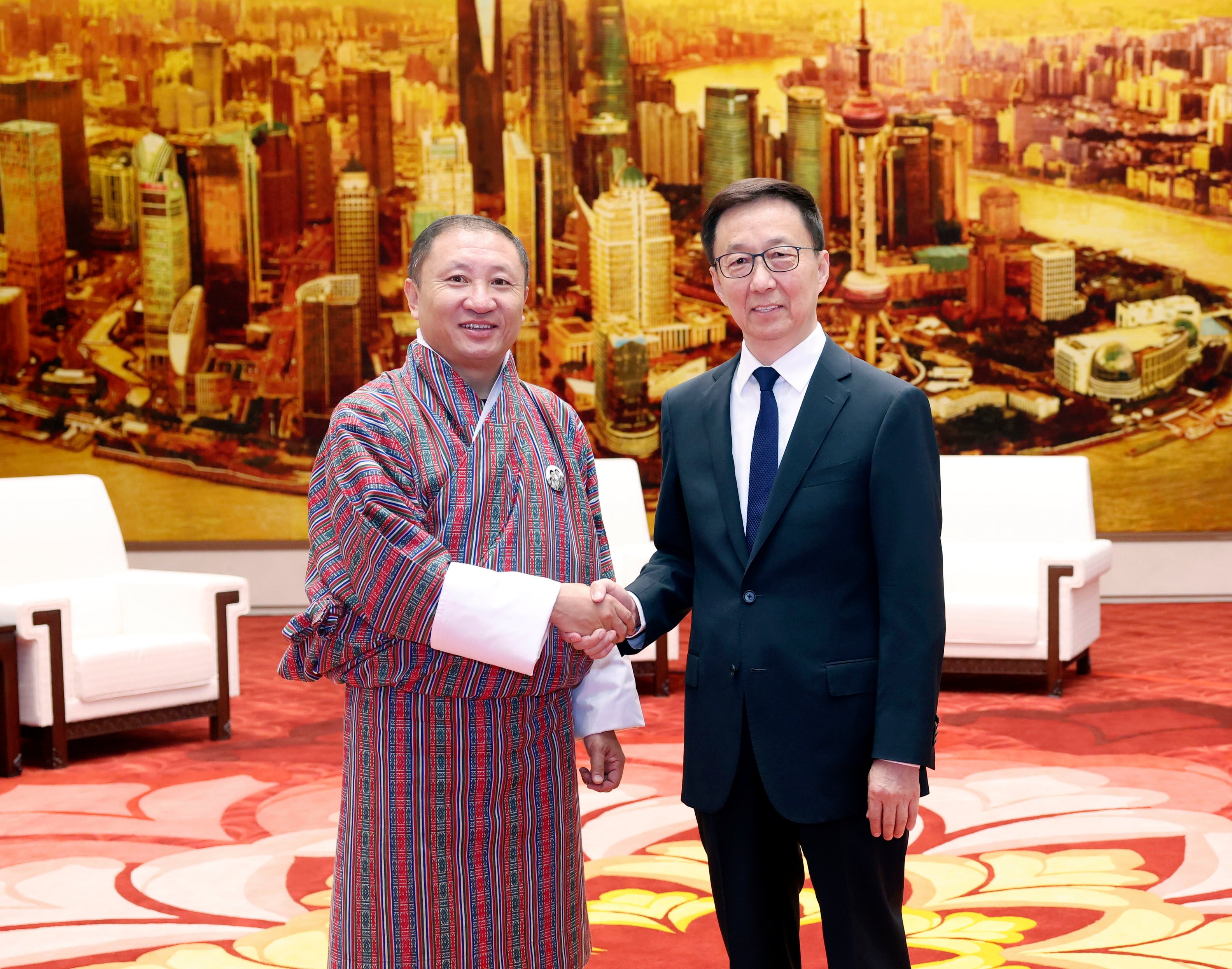 Bhutanese Foreign Minister Tandi Dorji (left) shakes hands with Chinese Vice-President Han Zheng in Beijing on Tuesday. Photo: Xinhua